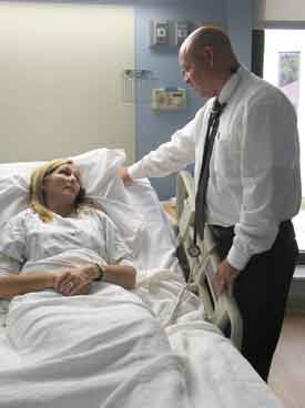 Doctor With Patient At Inpatient Care Facility